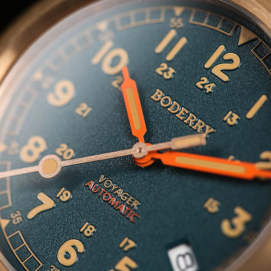 Official close-up photograph of the BODERRY Voyager Bronze Sandstone Green dial texture, bronze-toned numerals and orange hands.