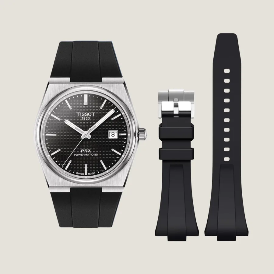 Epoch reference photo showing the black rubber strap fitted to a black-dial Tissot PRX Powermatic 80 beside the detached strap sections.